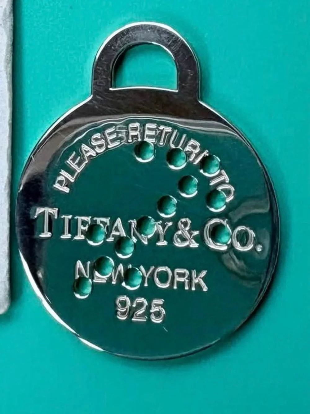Tiffany & Co. Silver Round Return-to Tag on Tiffany Blue